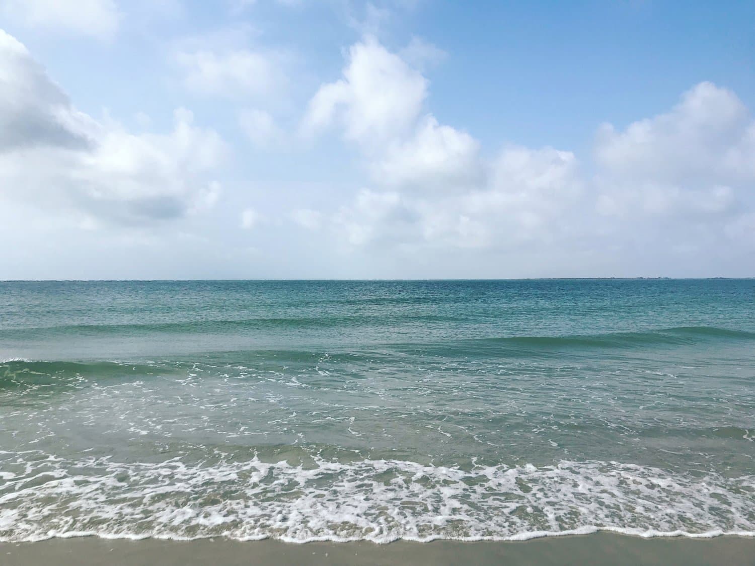 Ocracoke Island's wide, uncrowded beach and horizon, reachable only by ferry, boat, or plane